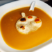 Bowl of Butternut squash soup with a pumpkin shaped tortilla bread on top